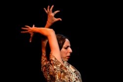 FILE - Mariana Collado, dancer at tavern-restaurant and flamenco tablao Casa Patas, performs at Casa Patas, which is closed due to the COVID-19 lockdown in Madrid, Spain, June 2, 2020.