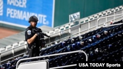 Police check out a vacated stadium after a game was postponed due to gunfire outside the stadium at Nationals Park, Washington, D.C., Jul 17, 2021. (Brad Mills-USA Today Sports)