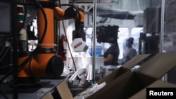 A Rapid Robotics robot moves products inside a Westec Plastics Corp warehouse in Livermore, California, U.S. on August 19, 2021. (REUTERS/Nathan Frandino)