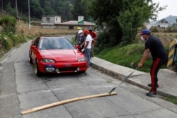Community members wearing protective masks operate a checkpoint at the entrance to the village of Paqui amid the outbreak of the coronavirus disease (COVID-19), in Totonicapan, Guatemala, April 19, 2020.