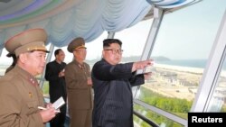 FILE - North Korean leader Kim Jong Un inspects the construction site of the Wonsan-Kalma tourist area as Kim Su Gil, third from left, new director of the General Political Bureau of the Korean People's Army, looks on, in this undated photo.