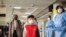 Passengers arriving from a China Southern Airlines flight from Changsha in China are screened for the new type of coronavirus, upon their arrival at the Jomo Kenyatta international airport in Nairobi, Kenya, Jan. 29, 2020. 