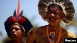 FILE - Indigenous people from ethnic groups Pataxo and Tupinamba attend a protest to defend indigenous land, outside Brazil's Supreme Federal Court in Brasilia, Brazil, Oct. 16, 2019. 