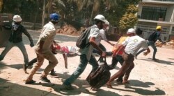 People carry Chit Min Thu on a stretcher during an anti-coup protest in North Dagon, Yangon, Myanmar, March 11, 2021 in this still image obtained by Reuters.