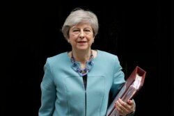 FILE - Theresa May leaves 10 Downing Street in London, to attend Prime Minister's Questions at the Houses of Parliament, June 19, 2019.