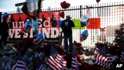 FILE - A makeshift memorial site honors shooting victims in San Bernardino, California, Dec. 7, 2015.