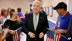 FILE- Arizona Republican Senator John McCain, center, endorses the Trans-Pacific Partnership.