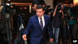 FILE - Selahattin Demirtas, co-leader of the pro-Kurdish Peace and Democracy Party, arrives for a meeting with representatives of minorities living in Turkey at a hotel in central Istanbul ahead of elections, Oct. 28, 2015.