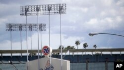 FILE - The exterior of Dodgers Stadium, home of the Los Angeles Dodgers is seen Wednesday, March 25, 2020, in Los Angeles.