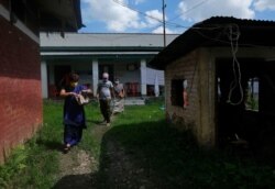 People leave a vaccination center after receiving the COVID-19 vaccine in Imphal, India, June 21, 2021.