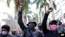 People protest against crimes committed by the police against black people in the favelas, outside the Rio de Janeiro's state government, Brazil, Sunday, May 31, 2020.