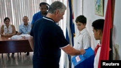 FILE - Cuba's President Miguel Diaz-Canel casts his vote during the referendum to approve the constitutional reform in Havana, Cuba, Feb. 24, 2019. 