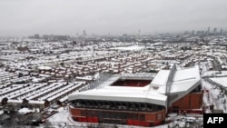 ພາບຖ່າຍທາງອາກາດທີ່ຖ່າຍໃນວັນທີ 5 ມັງກອນ 2025 ສະແດງໃຫ້ເຫັນສະໜາມກິລາ Anfield ໃນເມືອງ Liverpool ທາງພາກຕາເວັນຕົກສຽງເໜືອຂອງອັງກິດ, ມີຫິມະປົກຄຸມຢູ່ຕໍ່ໜ້າການແຂ່ງຂັນບານເຕະພຣີເມຍລີກ ອັງກິດ ລະຫວ່າງ ລິເວີພູລ ກັບ ແມນເຊັສເຕີ ຢູໄນເຕັດ, ໃນຂະນະທີ່ຫິມະຕົກໜັກຢູ່ທົ່ວບາງສ່ວນຂອງປະເທດອັງກິດ.