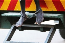 A man arrested for protesting over human rights abuses makes a court appearance in leg irons in Harare, Zimbabwe, Sept, 14, 2020.