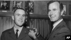 George W. Bush, left, is shown with his father, George H.W. Bush in this photo from 1968. 