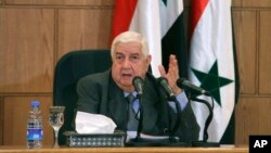 왈리드 모알렘 시리아 외무장관은 6일 다마스쿠스에서 기자회견을 하고 있다.