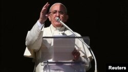 Pope Francis blesses during his Sunday Angelus prayer in Saint Peter's Square at the Vatican, Nov. 16, 2014.