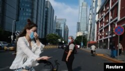 중국 베이징의 상업지구에서 시민들이 신종 코로나바이러스 감염증(COVID-19)를 막기 위해 마스크를 착용하고 있다. 