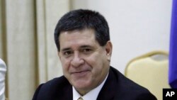 FILE - Paraguay's President Horacio Cartes, a former soft drink and tobacco businessman who took office in 2013, has raised Paraguay's presence in international bond markets. 