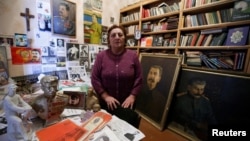 Nazi Stefanishvili, a 73-year-old retired economist, poses for a portrait in a room dedicated to Stalin at her home in Gori, Georgia, Dec. 6, 2016. 
