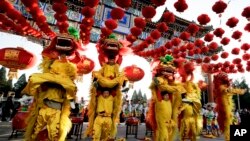 Performers participate in a lion dance at Ditan Park to mark the first day of Chinese Lunar New Year in Beijing, Monday, Feb. 8, 2016.