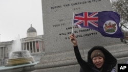 FILE - A Hong Kong activist takes part in a protest against Hong Kong's national security law, the Basic Law Article 23, approved by Hong Kong lawmakers, in London, March 23, 2024.