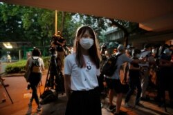 FILE - Pro-democracy activist Agnes Chow speaks to the media after reporting to police to extend her bail in Hong Kong, Sept. 1, 2020. Chow was arrested Aug. 10 under Hong Kong's National Security Law, for allegedly inciting secession, she said.