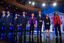 Democratic presidential hopefuls, from left, Bill de Blasio, Tim Ryan, Julian Castro, Cory Booker, Elizabeth Warren, Beto O'Rourke, Amy Klobuchar and Tulsi Gabbard arrive to the first Democratic primary debate in Miami, June 26, 2019.