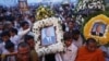 Thousands of mourners gather at the gates of the Royal Palace minutes after the coffin of former king Norodom Sihanouk arrived in Phnom Penh October 17, 2012. Tens of thousands poured into Cambodia's capital to witness the procession on Wednesday.