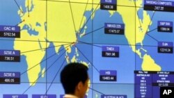 FILE - Screen shows world indexes at the Hong Kong Stock Exchange.