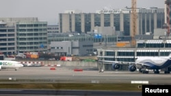 Emergency services (L) at the scene of explosions at Zaventem airport near Brussels, Belgium, March 22, 2016.