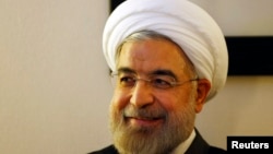 Iranian President Hassan Rouhani listens to WEF founder Klaus Schwab (not pictured) during a meeting at the annual meeting of the World Economic Forum (WEF) 2014 in Davos, Switzerland, Jan. 22, 2014.