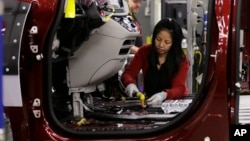 FILE - An employee works on a 2017 Chrysler Pacifica on an assembly line at the Windsor Assembly Plant, in Windsor, Canada, May 6, 2016.