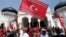 An Acehnese man waves a Crescent-Star flag during a rally outside Baiturrahman Grand Mosque in Banda Aceh, Aceh province, Indonesia, April 1, 2013.