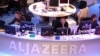 FILE - Al Jazeera English Channel staff prepare for the broadcast in Doha news room in Qatar.