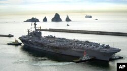 The aircraft carrier USS George Washington (CVN 73) departs Busan, Republic of Korea, 25 July 2010