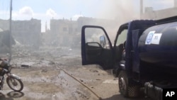 Image posted on Twitter account of Syria Civil Defense, also known as the White Helmets, a volunteer search and rescue group, shows the aftermath of purportedly Russian airstrike in Talbiseh, Syria, Sept. 30, 2015.