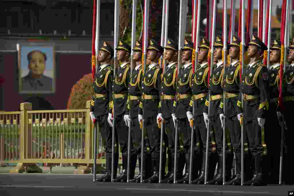 Members of a honor guard line up in formation near a large portrait of Chinese leader Mao Zedong on Tiananmen Gate before a welcome ceremony for Kazakhstan&#39;s President Nursultan Nazarbayev at the Great Hall of the People in Beijing.