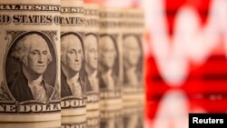 FILE PHOTO: U.S. One dollar banknotes are seen in front of displayed stock graph in this illustration taken, February 8, 2021. REUTERS/Dado Ruvic/Illustration/File Photo