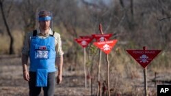 Britain's Prince Harry walks through a minefield in Dirico, Angola Friday Sept. 27, 2019.