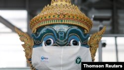 A Thai traditional giant statue wears a protective mask, amid the coronavirus disease (COVID-19) pandemic, at Suvarnabhumi Airport in Bangkok, Thailand Dec. 15, 2020.