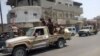 In this frame grab from video provided by Yemen Today, Yemeni army vehicles enter Zinjibar, Yemen, Aug. 28, 2019. 