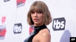 FILE - Taylor Swift arrives at the iHeartRadio Music Awards at The Forum on April 3, 2016, in Inglewood, California.