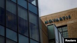 FILE - A sign marks a building on Novartis' campus in Cambridge, Massachusetts, Feb. 28, 2017. 