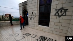 Palestinians inspect the damage done to a mosque, after a reported attack by Israeli settlers, in the town of Marda near the West Bank city of Salfit on Dec. 20, 2024. 