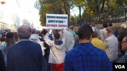 2014年9月莫斯科的反对侵略乌克兰和反战大游行中，一名示威者手举标语，终生独裁意味着总是不停发动战争。类似的游行集会目前已经越来越难举办。