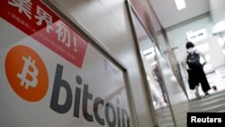 FILE - A logo of Bitcoin is seen on an advertisement of an electronic shop in Tokyo, Japan September 5, 2017. REUTERS/Kim Kyung-Hoon/File Photo