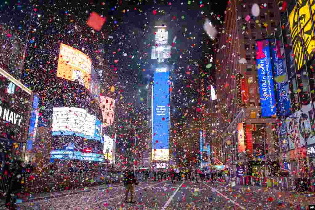 Confetti flies after the Times Square New Year&#39;s Eve Ball drops in a nearly empty Times Square, as the area normally packed with revelers remained closed off due to the ongoing coronavirus pandemic.