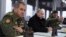 Владимир Путин и министр обороны России Сергей Шойгу (слева) 