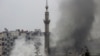 Smoke rises from a mosque and another building during heavy fighting in the Jobar area of Damascus Feb. 6, 2013. 